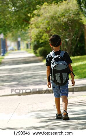 Boy taking a walk down the street View Large Photo Image Stock Photography - Boy taking a walk down the street. Fotosearch