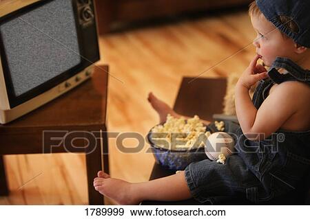 Stock Photo - Boy watching empty television. Fotosearch