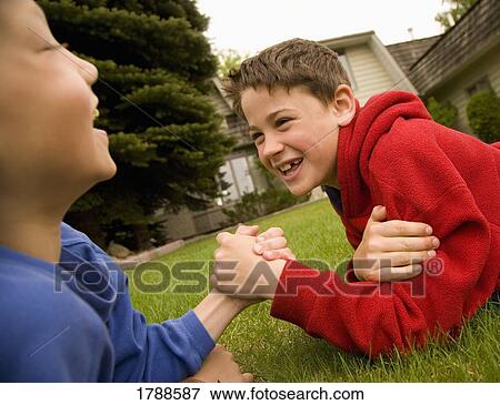 Boys arm wrestling View Large Photo Image Stock Photo - Boys arm wrestling. Fotosearch