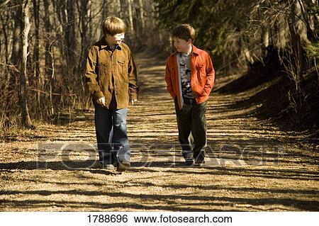 Boys going for a walk together View Large Photo Image Stock Photograph - Boys going for a walk together. Fotosearch
