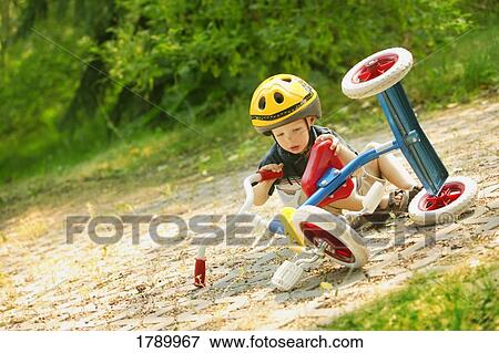 Child falling off tricycle View Large Photo Image Stock Photo - Child falling off tricycle. Fotosearch