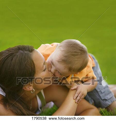 Stock Photo - Child kisses his mother. Fotosearch