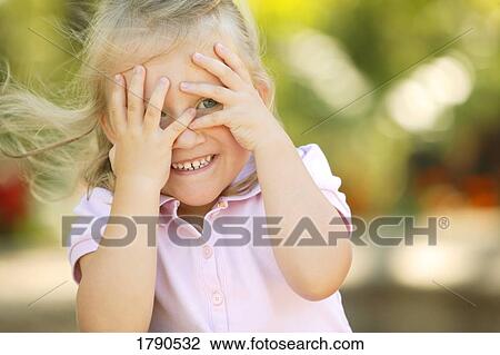 Child peeking through her hands View Large Photo Image Stock Image - Child peeking through her hands. Fotosearch