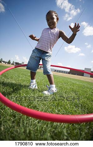 Child plays with hoop View Large Photo Image Stock Image - Child plays with hoop. Fotosearch