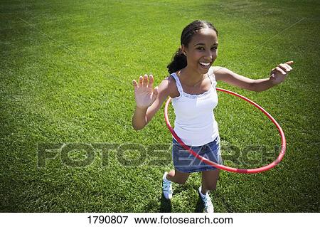 Stock Photo - Child plays with hoop. Fotosearch