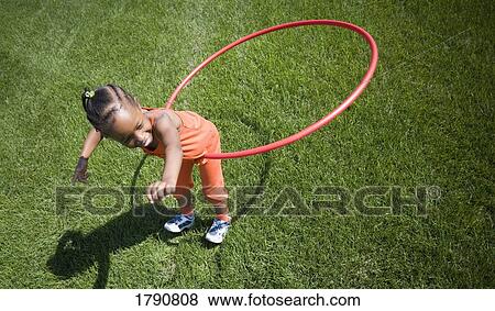 Child plays with hoop View Large Photo Image Stock Photo - Child plays with hoop. Fotosearch
