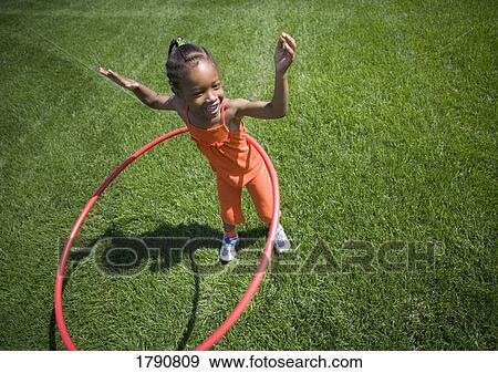 Child plays with hoop View Large Photo Image Stock Photo - Child plays with hoop. Fotosearch