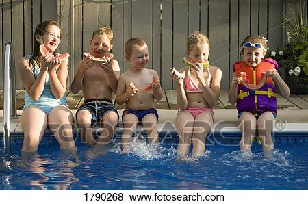 Children eating watermelon by pool View Large Photo Image Stock Photo - Children eating watermelon by pool. Fotosearch