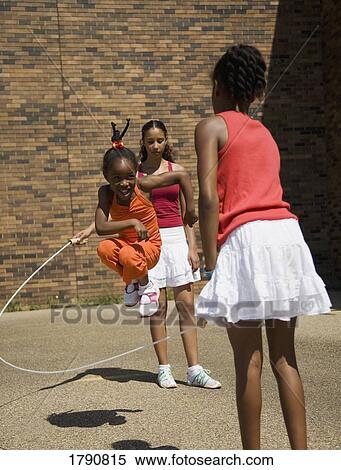 Children playing with a jumping rope View Large Photo Image Stock Photography - Children playing with a jumping rope. Fotosearch