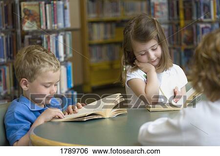 Children reading at library table View Large Photo Image Stock Photograph - Children reading at library table. Fotosearch