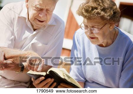 Couple study Bible together View Large Photo Image Stock Photo - Couple study Bible together. Fotosearch