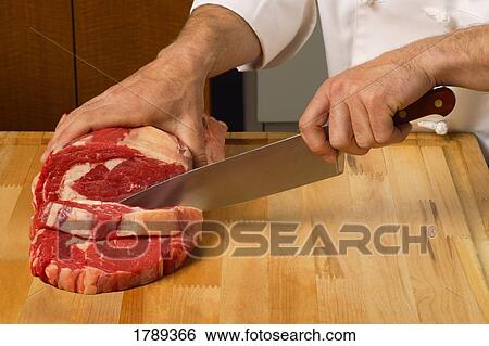 Cutting meat into steaks View Large Photo Image Stock Photograph - Cutting meat into steaks. Fotosearch