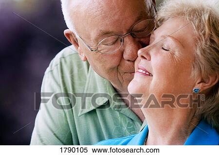 Elderly man kissing his wife View Large Photo Image Stock Photography - Elderly man kissing his wife. Fotosearch