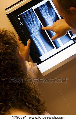 Stock Image - Examining x-rays. Fotosearch