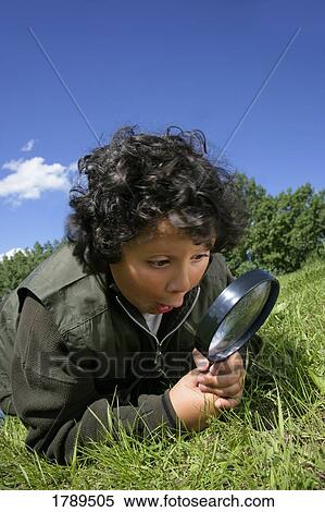 Stock Photography - Excited Boy with Magnifying Glass. Fotosearch