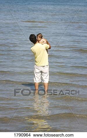 Father and baby in the water View Large Photo Image Picture - Father and baby in the water. Fotosearch