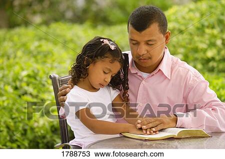 Stock Image - Father and daughter in prayer. Fotosearch