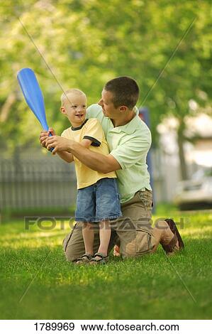 Stock Photo - Father and son playing ball. Fotosearch