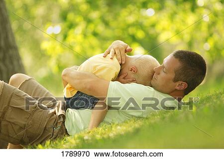 Stock Image - Father Comforting Son. Fotosearch
