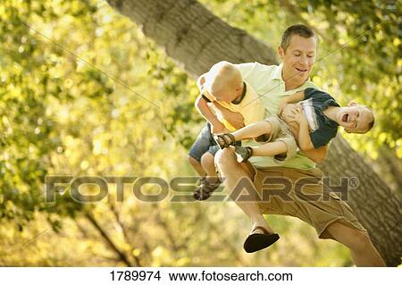 Father playing with sons View Large Photo Image Picture - Father playing with sons. Fotosearch
