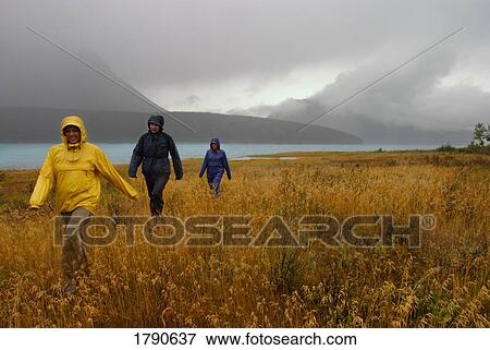 Friends hiking in the rain View Large Photo Image Stock Photo - Friends hiking in the rain. Fotosearch