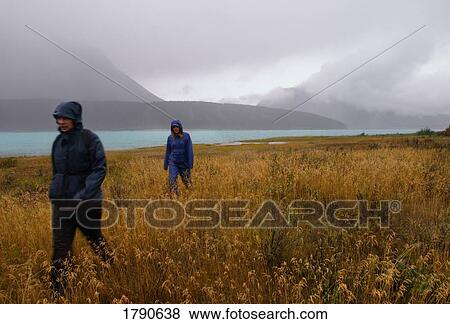 Stock Photo - Friends hiking in the rain. Fotosearch