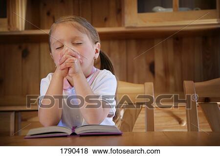 Stock Photo - Girl praying. Fotosearch