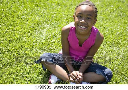 Girl sitting on grass View Large Photo Image Stock Photography - Girl sitting on grass. Fotosearch