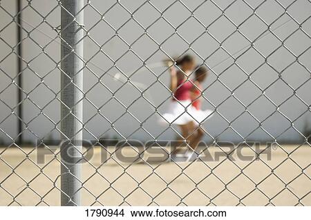 Girls skipping beyond a fence View Large Photo Image Picture - Girls skipping beyond a fence. Fotosearch