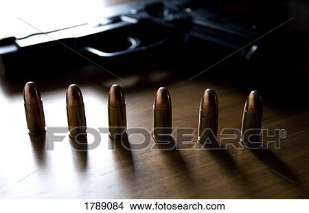 Picture - Handgun and bullets. Fotosearch