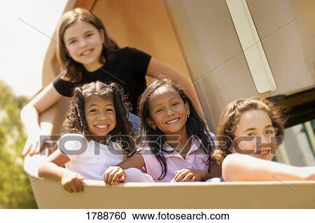 Stock Image - Kids on a slide. Fotosearch