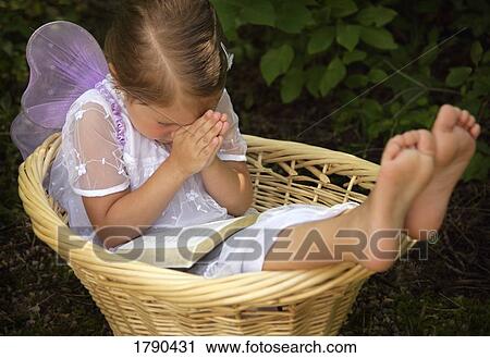 Stock Image - Little angel praying. Fotosearch