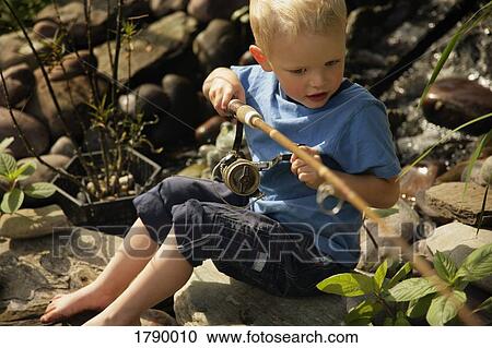 Stock Image - Little boy fishing. Fotosearch