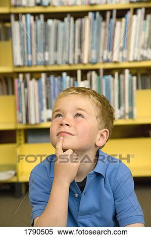 Little boy in library View Large Photo Image Stock Photography - Little boy in library. Fotosearch