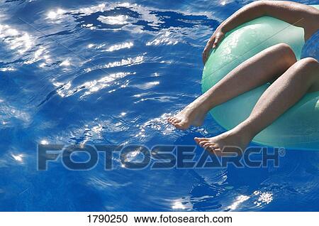 Little girl floating on a tube View Large Photo Image Stock Image - Little girl floating on a tube. Fotosearch