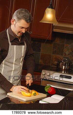 Man cooking in kitchen View Large Photo Image Stock Photo - Man cooking in kitchen. Fotosearch
