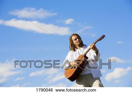 Man playing guitar View Large Photo Image Stock Photograph - Man playing guitar. Fotosearch