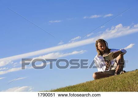 Man reading outdoors View Large Photo Image Stock Image - Man reading outdoors. Fotosearch