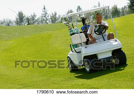 Man riding a golf cart View Large Photo Image Stock Image - Man riding a golf cart. Fotosearch