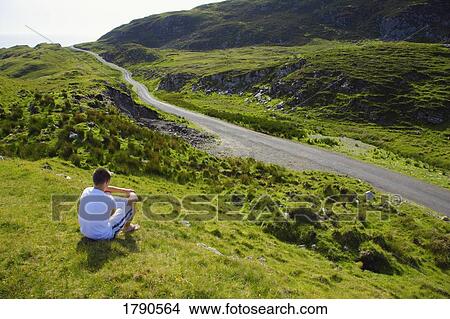 Man sitting beside road View Large Photo Image Picture - Man sitting beside road. Fotosearch