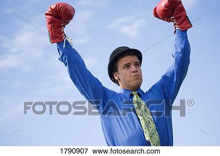 Stock Photo - Man wearing derby hat and boxing gloves. Fotosearch