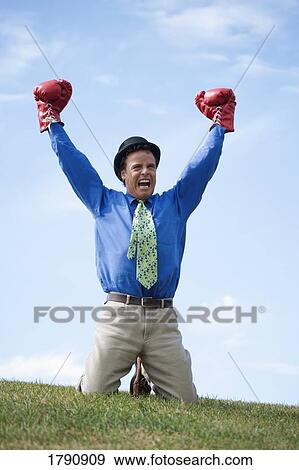 Man wearing derby hat and boxing gloves View Large Photo Image Stock Photo - Man wearing derby hat and boxing gloves. Fotosearch