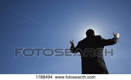 Man with arms raised to the sky View Large Photo Image Picture - Man with arms raised to the sky. Fotosearch