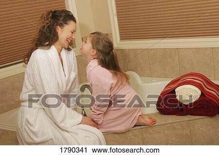 Mother and daughter preparing a bath View Large Photo Image Stock Image - Mother and daughter preparing a bath. Fotosearch