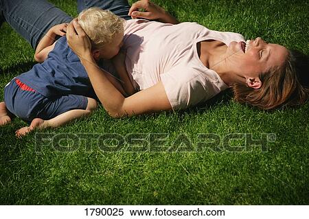 Mother and son playing in grass View Large Photo Image Stock Photography - Mother and son playing in grass. Fotosearch