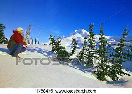 Stock Photograph - Person on snow-covered slope. Fotosearch