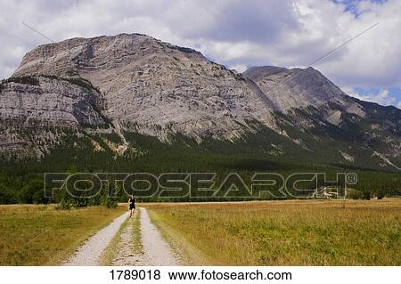 Person running on dirt road View Large Photo Image Stock Photo - Person running on dirt road. Fotosearch