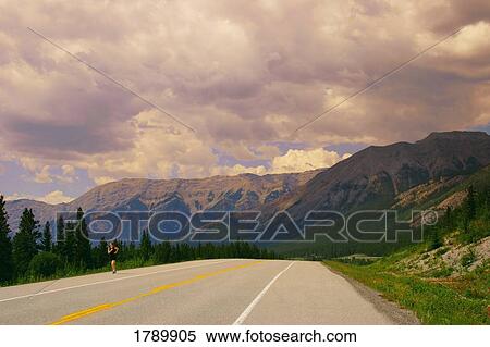 Person running on side of highway View Large Photo Image Stock Photography - Person running on side of highway. Fotosearch