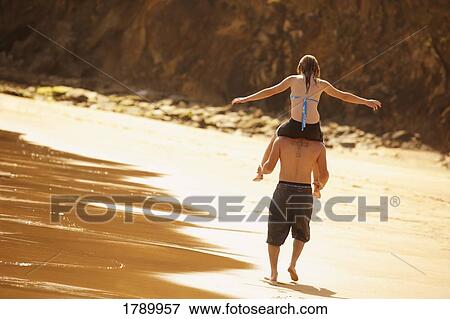 Stock Photo - Playing on the beach. Fotosearch