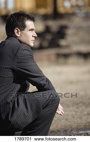 Stock Image - Profile of man wearing a suit. Fotosearch